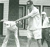 Bud Heyman (foreground), along with golfing partners Joe Dolan (left) and Spike Berg, stretch before teeing off at the American Legion Golf Course.