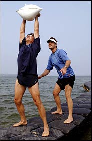 The trainer Paul Frediani monitors the workout of his client, Jim Peterson, on a floating dock at Maidstone Beach in East Hampton.