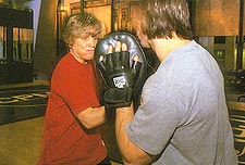 Psychologist Ellen McGrath spars with trainer Mark Tenore